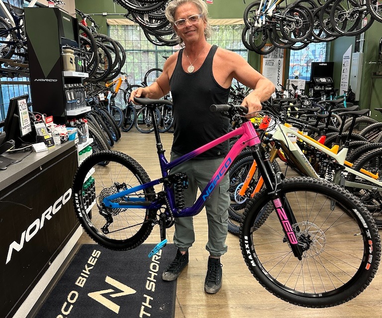 person lifting a mountain bike